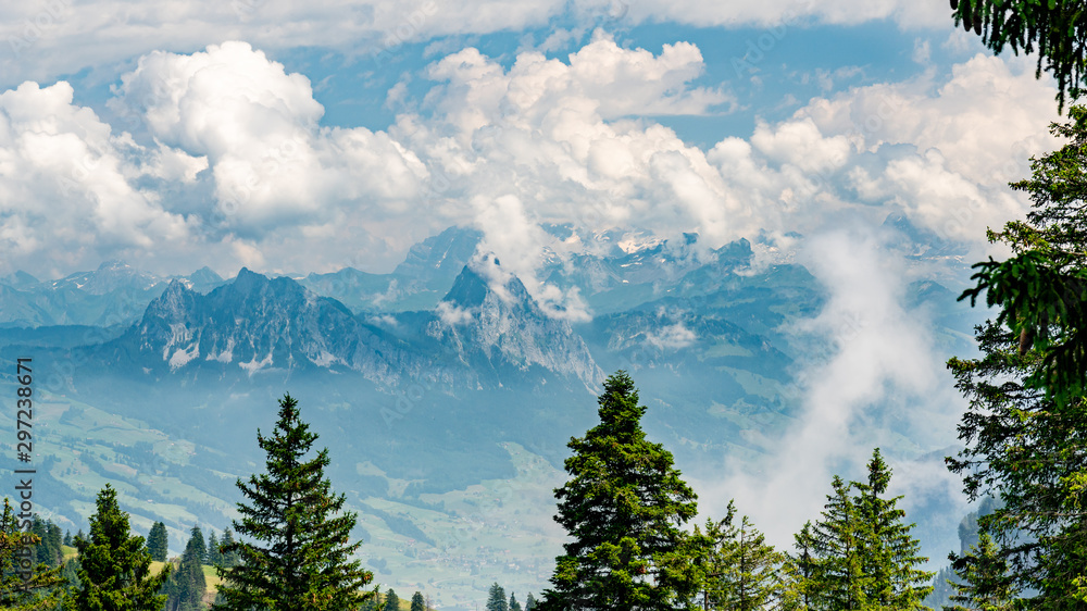 Switzerland, Panoramic view on green Alps and Mythens peak in clouds