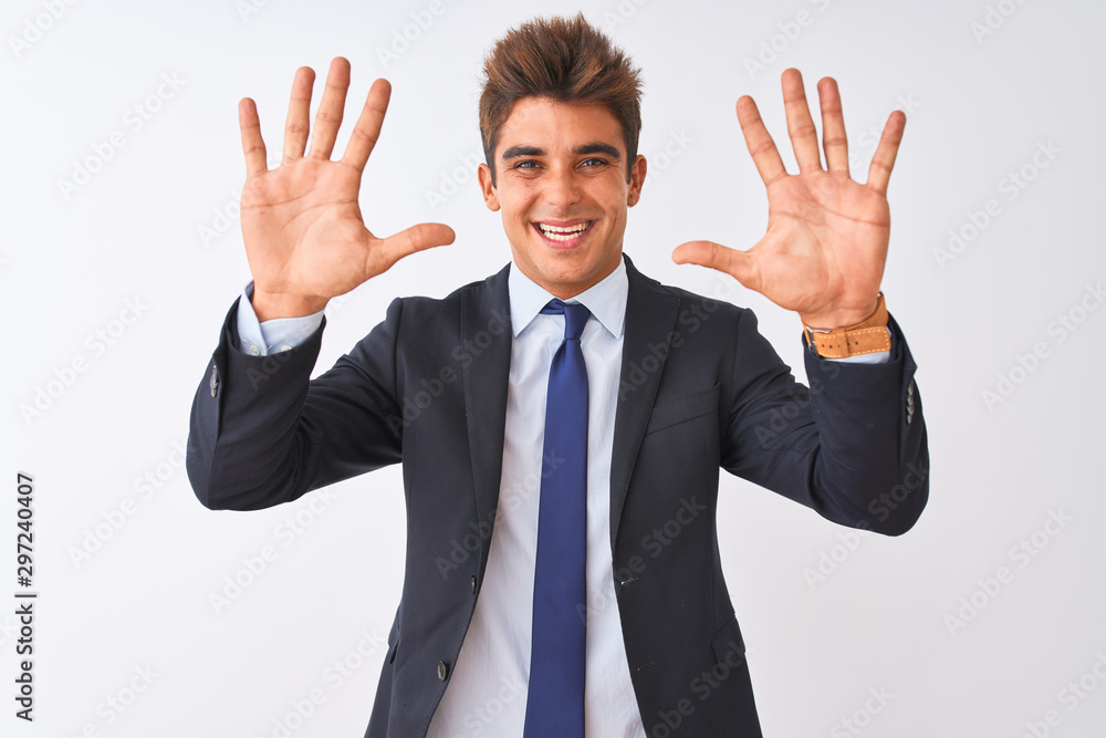 Young handsome businessman wearing suit standing over isolated white background showing and pointing up with fingers number ten while smiling confident and happy. Young handsome businessman wearing suit standing over isolated white background showing and pointing up with fingers number ten while smiling confident and happy.