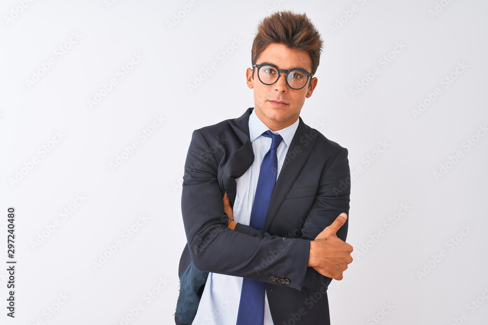Young handsome businessman wearing suit and glasses over isolated white background skeptic and nervous, disapproving expression on face with crossed arms. Negative person. Young handsome businessman wearing suit and glasses over isolated white background skeptic and nervous, disapproving expression on face with crossed arms. Negative person.