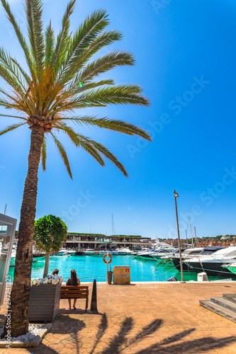 Majorca, Spain - June 1st 2018: Beautiful promenade of Port Adriano with luxury yachts boats © vulcanus