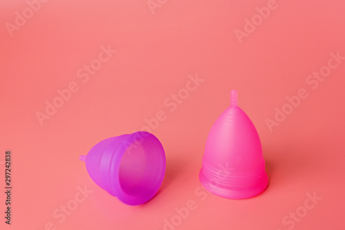 Menstrual cups on pink background. Alternative feminine hygiene product during the period. Women health concept. Copy space. Eco friendly concept, zero waste product. mockup, template