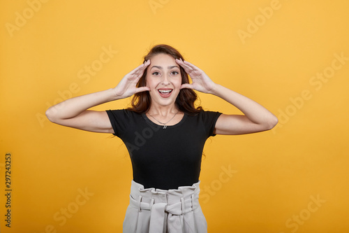 Beautiful girl trying very hard as student is forcefully opening her eyes to concentrate. She is studying at night which is shown in the picture as tomorrow is her exam.