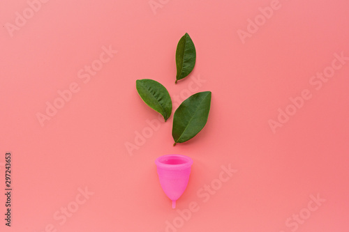Menstrual cup on pink background. Alternative feminine hygiene product during the period. Women health concept. Copy space. Eco friendly concept, zero waste product. Flat lay, mockup, template photo