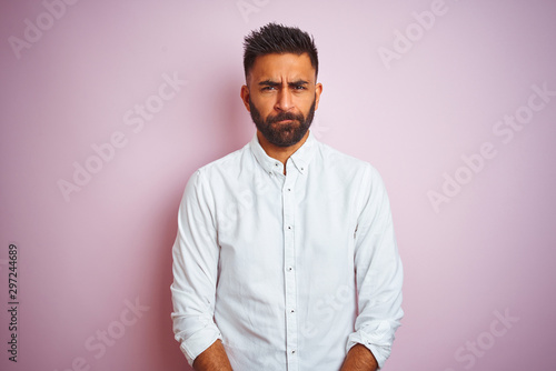 Young indian businessman wearing elegant shirt standing over isolated pink background skeptic and nervous, frowning upset because of problem. Negative person. © Krakenimages.com