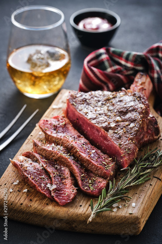 Entrecote. Steak on the bone. Rib eye. Tomahawk steak on the on a cutting board with rosemary. Roasting - Rare
