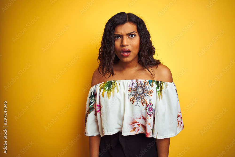 Transsexual transgender woman wearing summer t-shirt over isolated yellow background afraid and shocked with surprise expression, fear and excited face. Transsexual transgender woman wearing summer t-shirt over isolated yellow background afraid and shocked with surprise expression, fear and excited face.