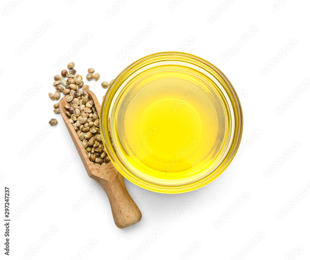 Bowl with hemp oil and seeds on white background, top view - obrazy, fototapety, plakaty 