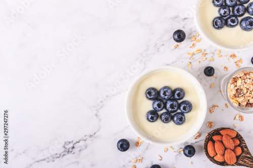 Yogurt with fresh blueberries on wooden background. Health concept.