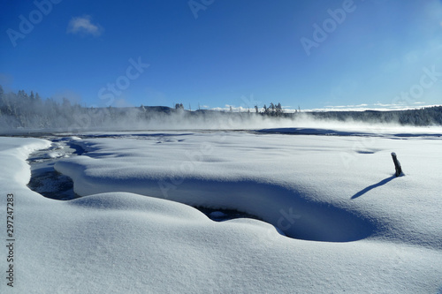 Morning fog above Yellowstone plain covered by snow in winter, United States