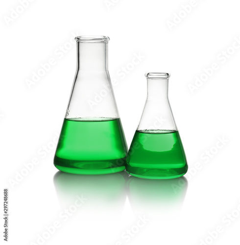 Conical flasks with green liquid on white background