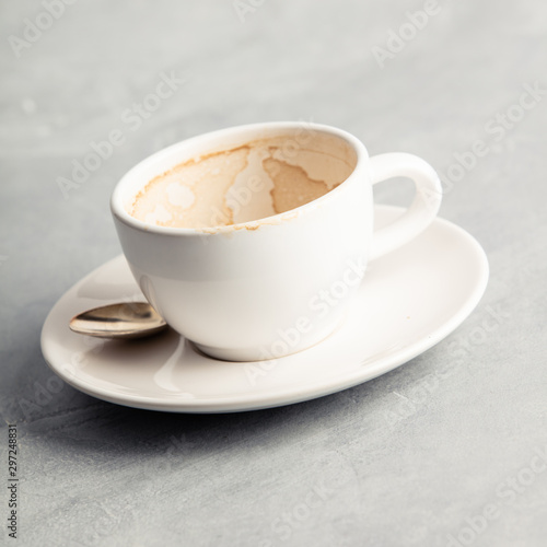 Empty coffee cup after drink on concrete background