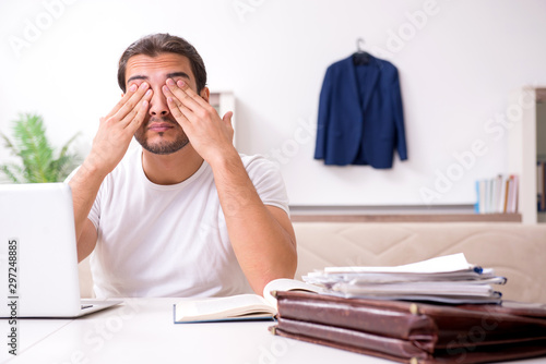 Young male student preparing for exams at home