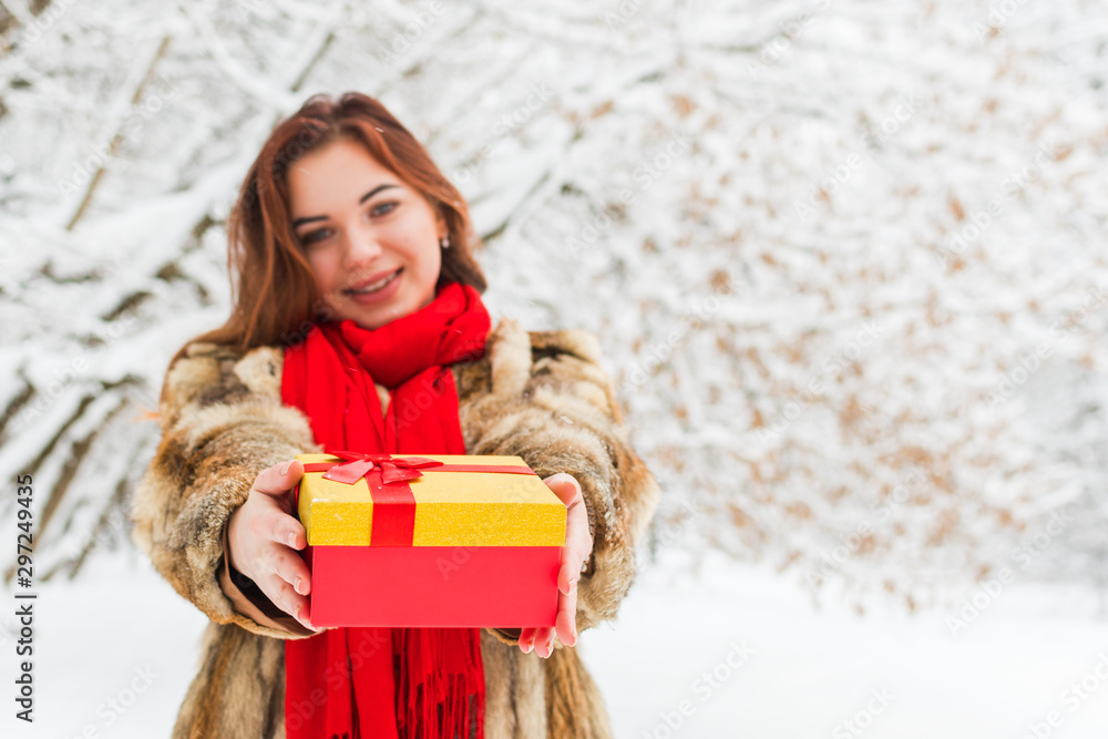 gift in the hands of a beautiful woman in the winter forest gift in the hands of a beautiful woman in the winter forest