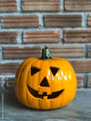 Halloween pumpkin on the cement floor with orange brick and dark light.