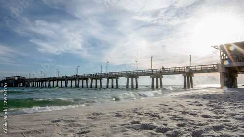 Long exposure of fishing pier with sunburst © jackienix