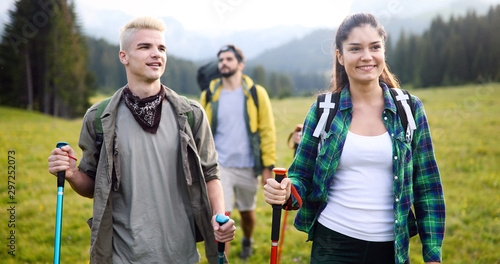 Couple - active hikers hiking enjoying view looking at mountain forest landscape