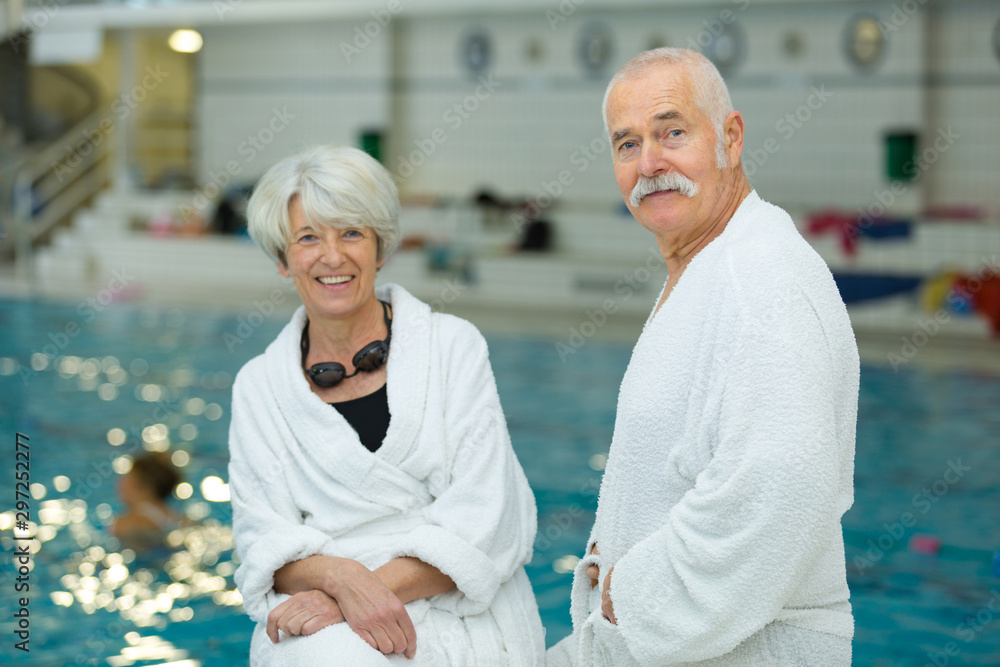 Fototapeta premium happy senior couple laughing in the pool