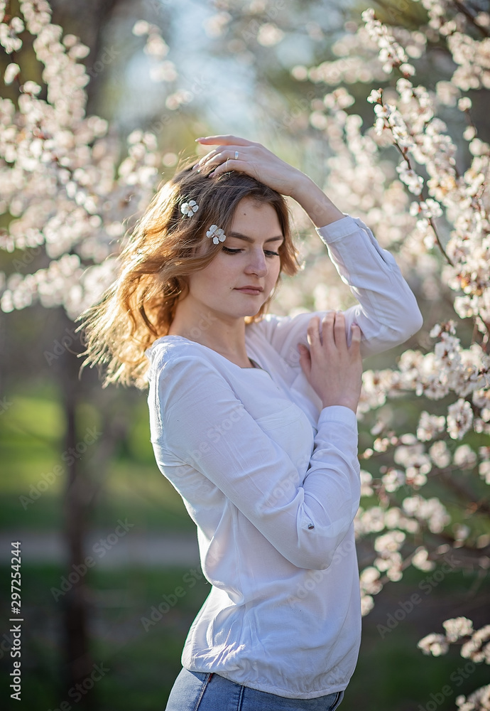 young girl in the garden in apricot trees young girl in the garden in apricot trees