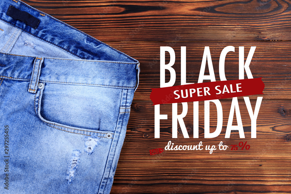 blue denim jeans on wooden background . Black friday sale Stock Photo |  Adobe Stock
