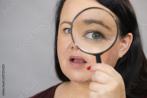 Adult woman with magnifying glass