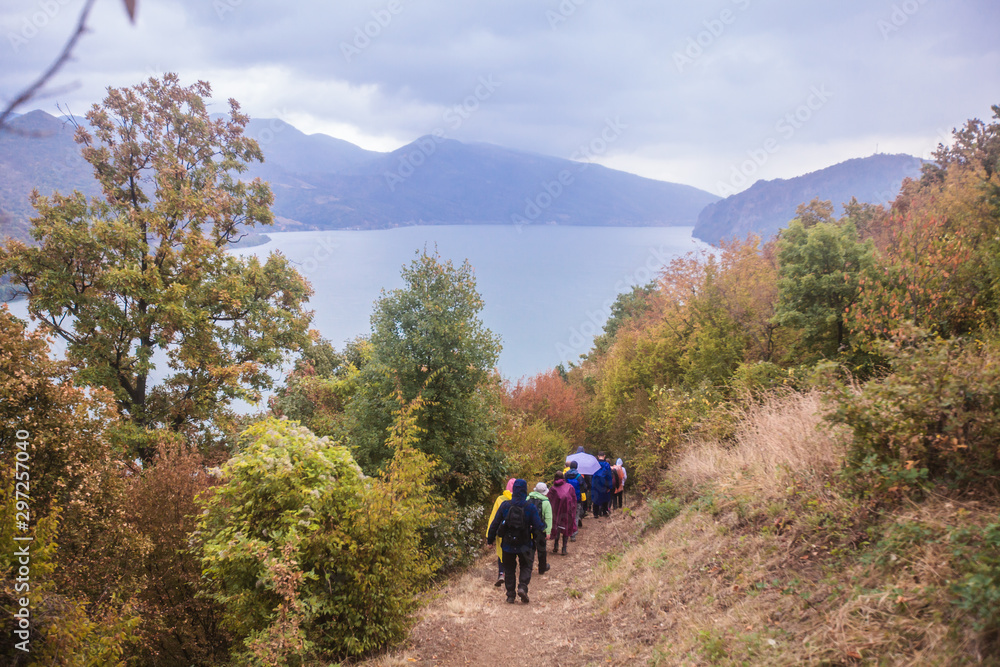 Group of active people hiking on the rural landscape