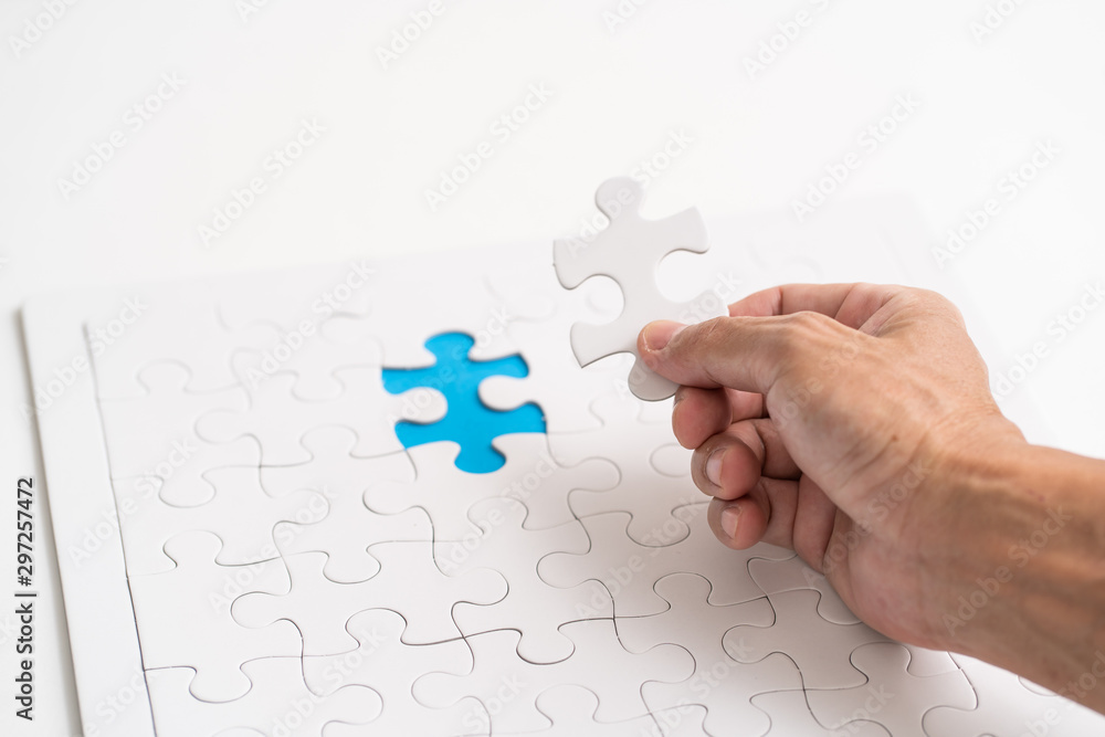 Hand holding jigsaw piece. for business concept