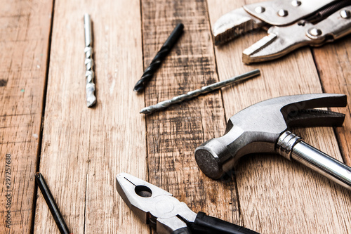 steel pliers and hammer carpenter tool on the wood background, woodden industry equipment for fix and building 