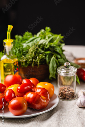 Ingredients for preparing vegetarian food. Tomatoes, peppers, garlic, basil, olive oil. Close-up.