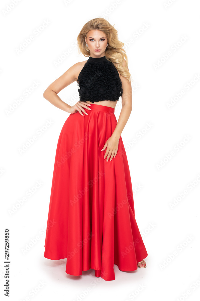 Attractive young fashion model wears a elegant red dress in studio and smiling