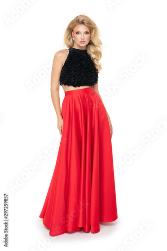 Attractive young fashion model wears a elegant red dress in studio and smiling