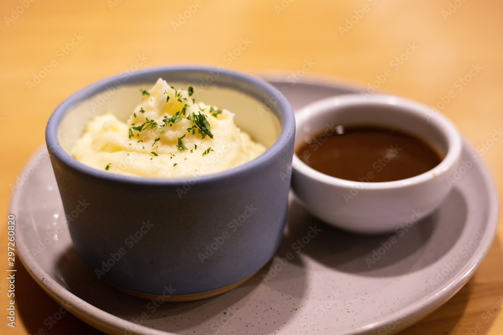 Mashed potatoes in bowl with pepper-cream gravy sauce. Mashed potatoes in bowl with pepper-cream gravy sauce.