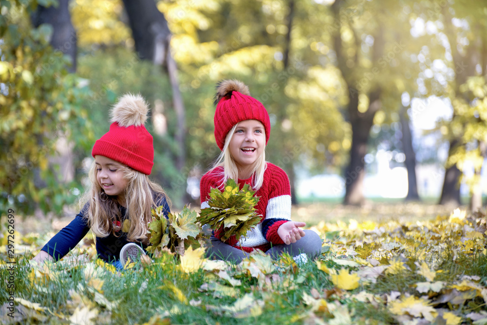 Two sweet little girl in the yellow leaves of autumn Two sweet little girl in the yellow leaves of autumn