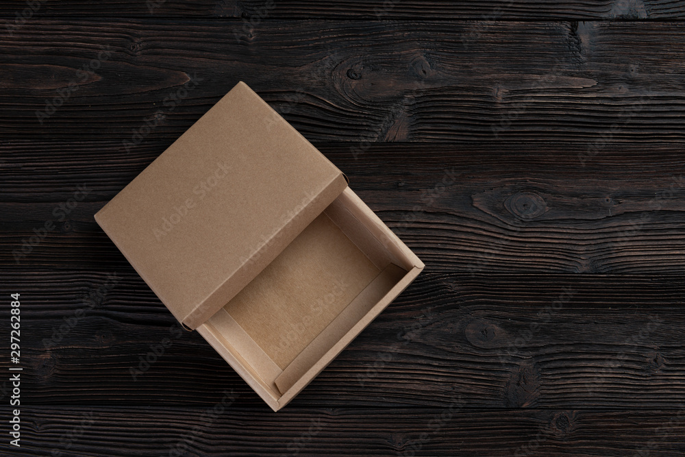 Fototapeta premium Cardboard box on a wooden background