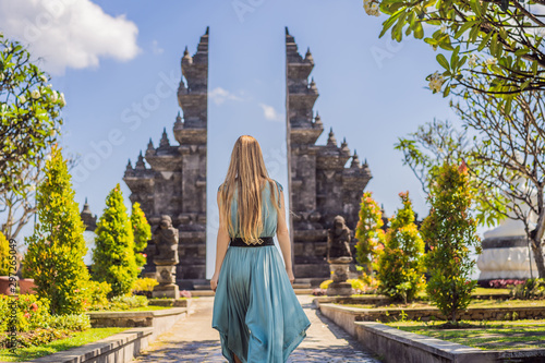 Young woman tourist in budhist temple Brahma Vihara Arama Banjar Bali, Indonesia photo