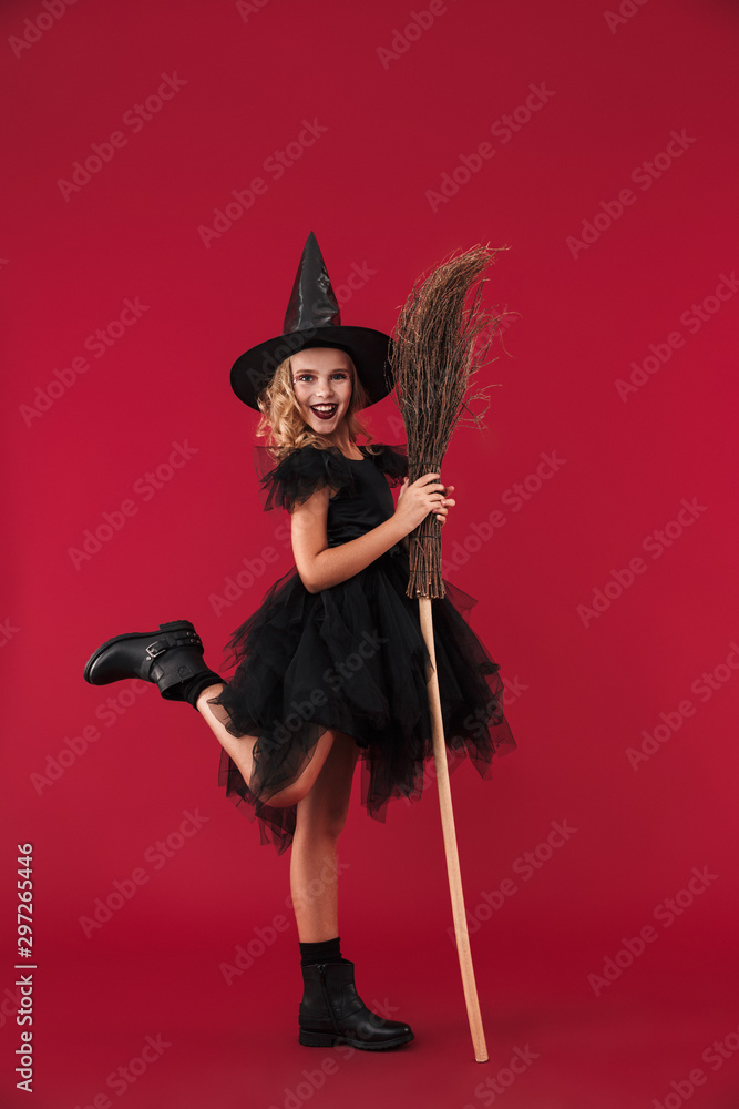 Pleased little girl witch in carnival halloween costume Pleased little girl witch in carnival halloween costume