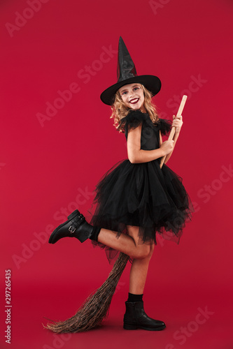 Little girl witch in carnival halloween costume