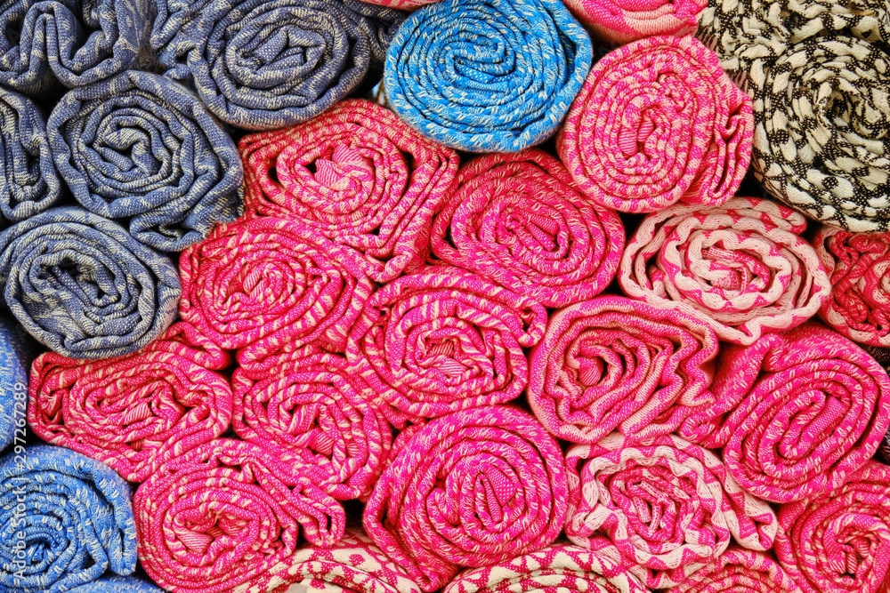 Background of rolled red towels, close-up. Texture colored cloth at the Bazaar in the Medina of Tunisia Background of rolled red towels, close-up. Texture colored cloth at the Bazaar in the Medina of Tunisia