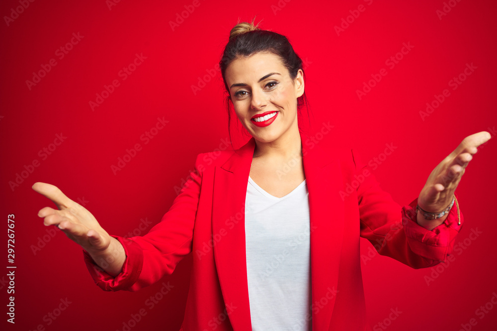 Young beautiful business woman standing over red isolated background smiling cheerful offering hands giving assistance and acceptance. Young beautiful business woman standing over red isolated background smiling cheerful offering hands giving assistance and acceptance.