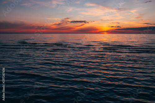 Evening by the sea  beautiful sunset over Baltic seashore  close up view on small waves