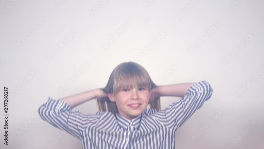 Beauty funny blonde teenage girl has a fun, jumping and laughing, white background. Happy joyful school girl with long blonde hair. Emotions. Slow motion 4K UHD video Beauty funny blonde teenage girl has a fun, jumping and laughing, white background. Happy joyful school girl with long blonde hair. Emotions. Slow motion 4K UHD video