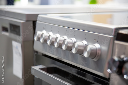 handles of a gas or electric stove, close-up, side view, soft focus