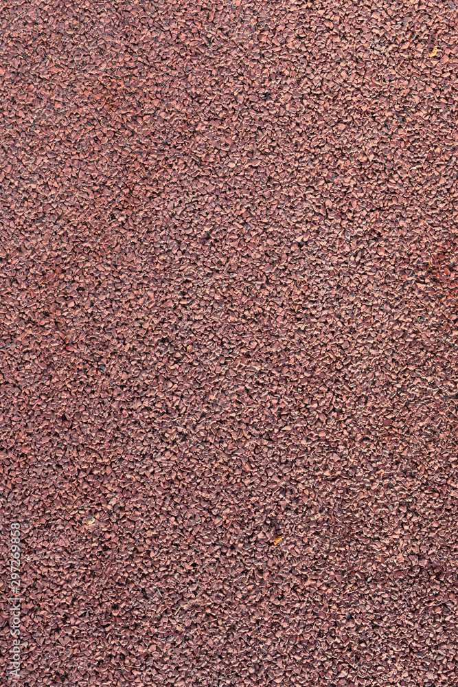Fototapeta premium Surface of rubber pellets in treadmill athletics field texture background. Braun shock absorbing coatings are made from rubber chips that are used in playgrounds, stadiums and sidewalks