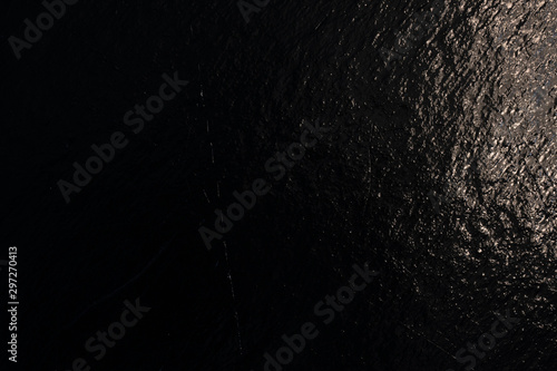 Black reflective background with metal texture. Retro backdrop. Vintage pattern.