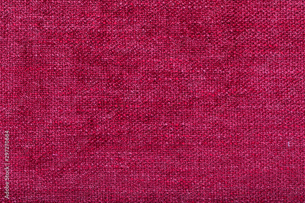Fototapeta premium shaggy surface. fine grain felt red fabric. texture polyester close-up. dark pink fleecy background.