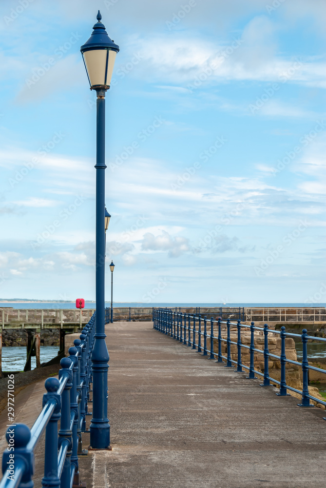An old blue street lamp on an English seaside pier