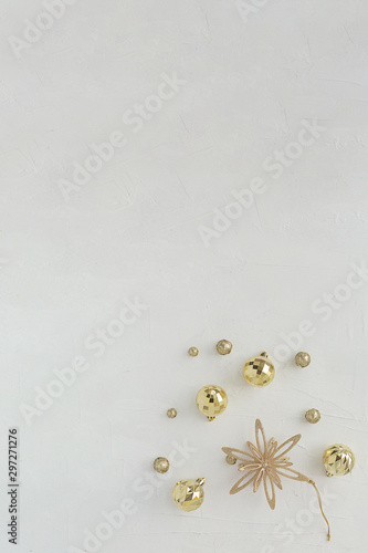 Christmas composition. New Year's composition. Golden star and balls on a light texture horizontal background.