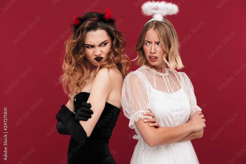 Angel and demon in carnival costumes isolated Angel and demon in carnival costumes isolated