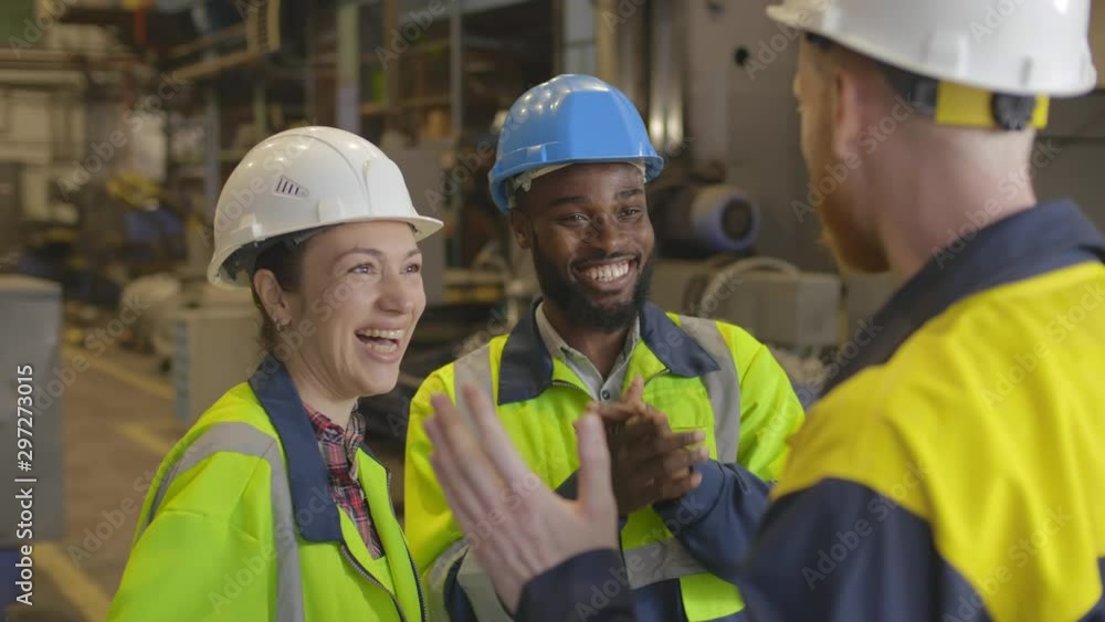Factory workers happy about success Factory workers happy about success