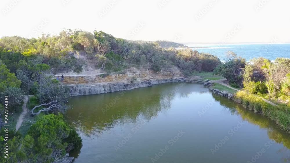 Aerial Drone Panning Above Angourie Rock Pools In Yamba Australia Towards Coastal Beach With Crashing Blue Waves Aerial Drone Panning Above Angourie Rock Pools In Yamba Australia Towards Coastal Beach With Crashing Blue Waves