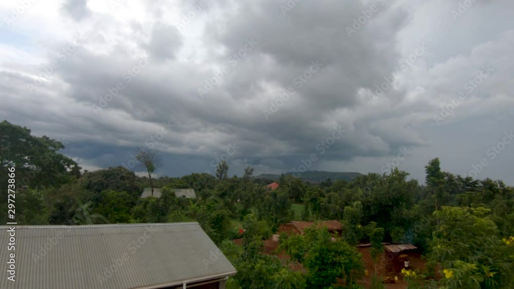 A time lapse of big dark storm clouds rolling in over a rural African village. A time lapse of big dark storm clouds rolling in over a rural African village.